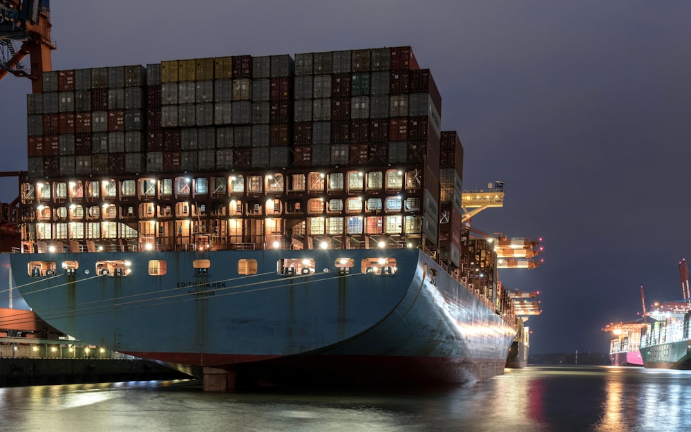 a large cargo ship in a harbor at night