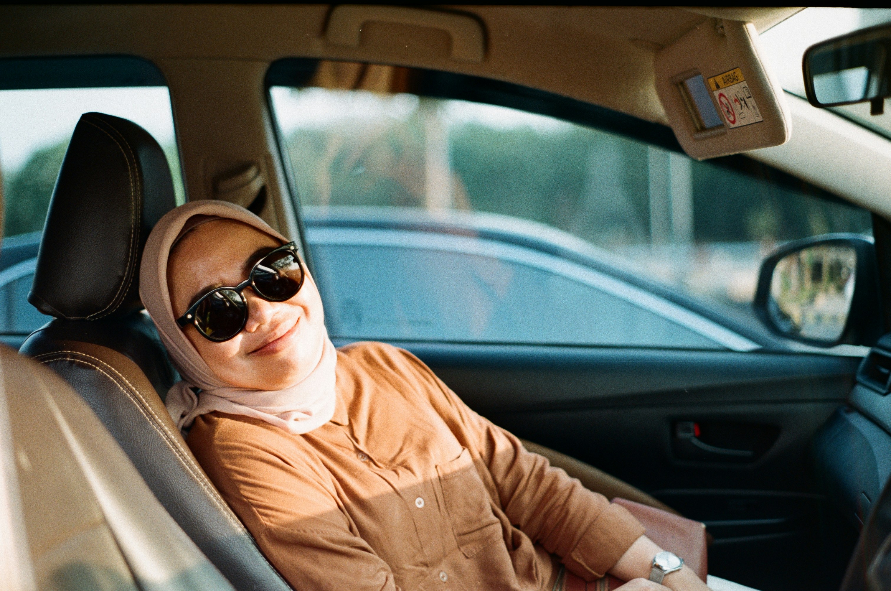 a woman sitting in the passenger seat of a car