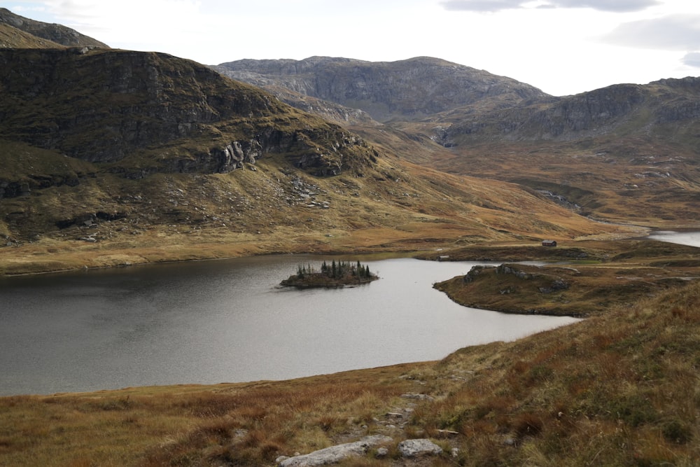 a small island in the middle of a mountain lake