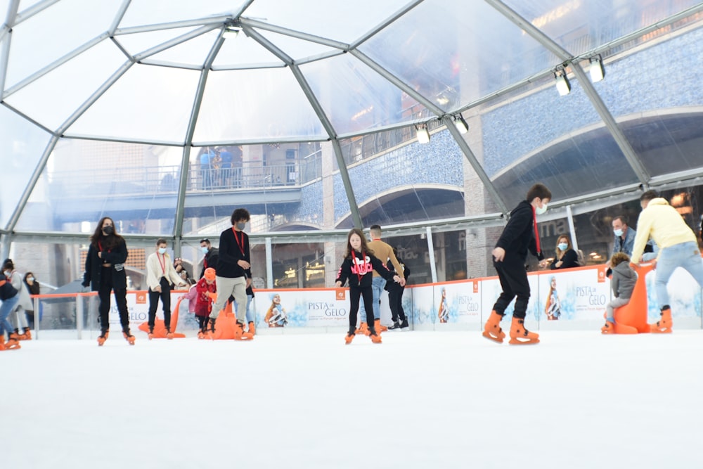 a group of people skating on an ice rink