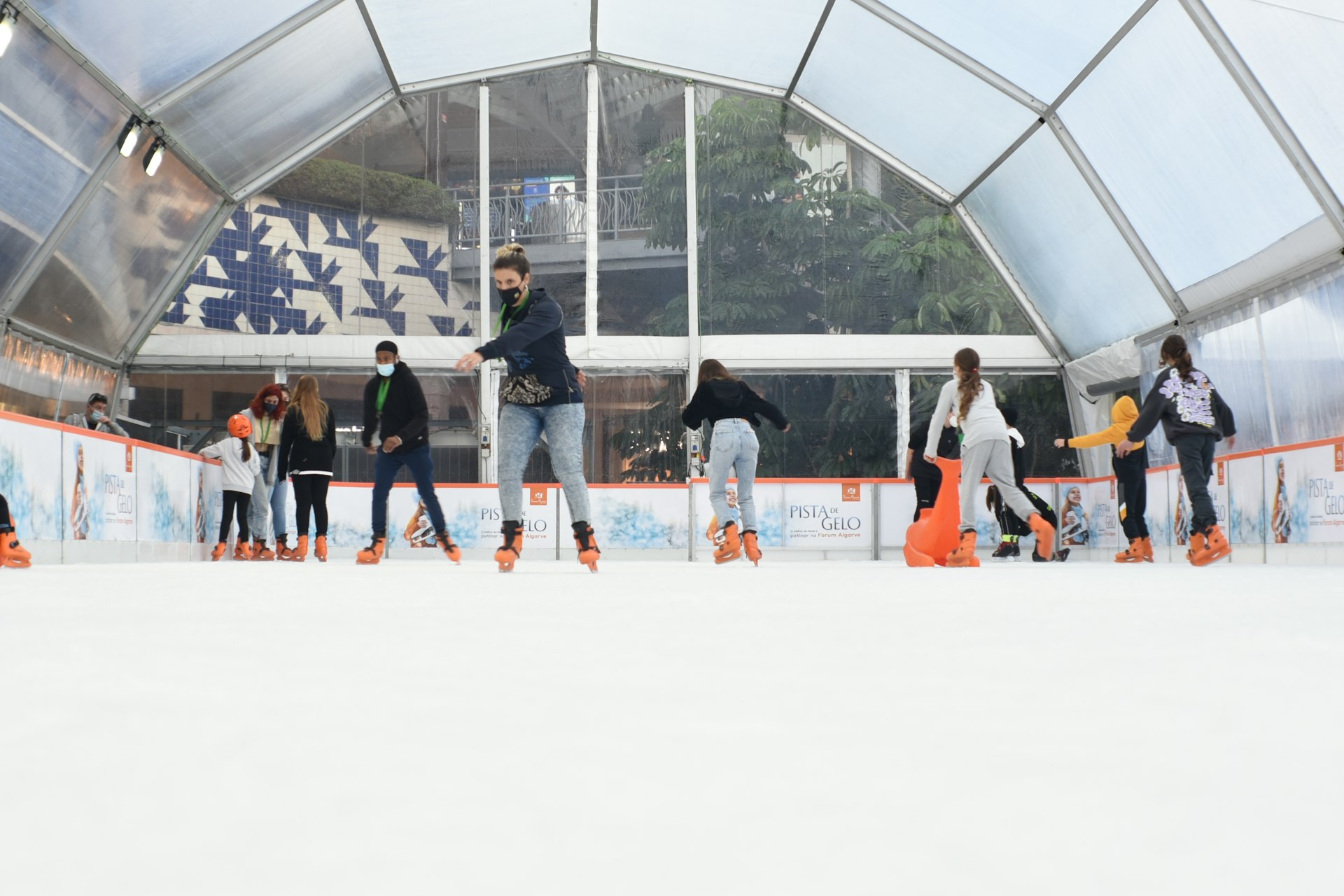a group of people skating on an ice rink
