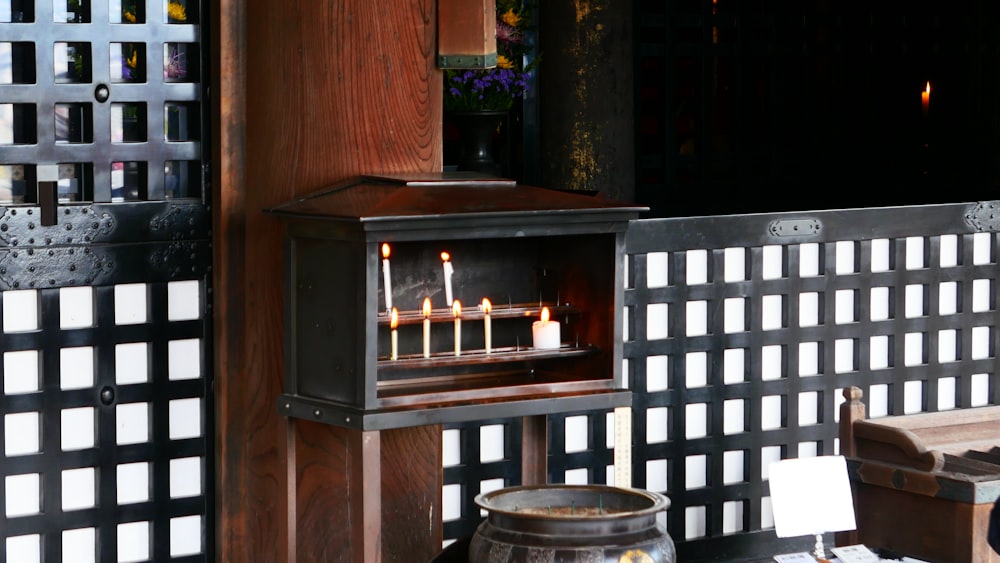 a wooden table topped with a lit candle