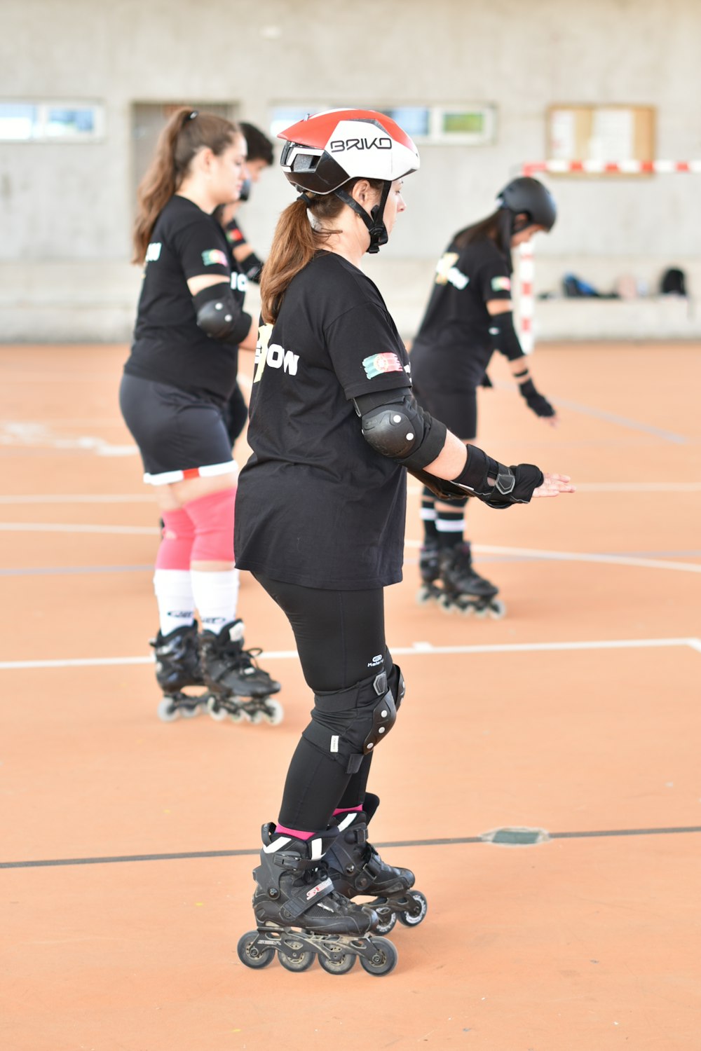 a group of people riding roller skates on a court