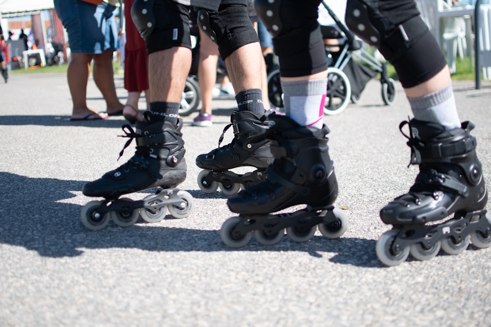 a group of people riding roller skates down a street