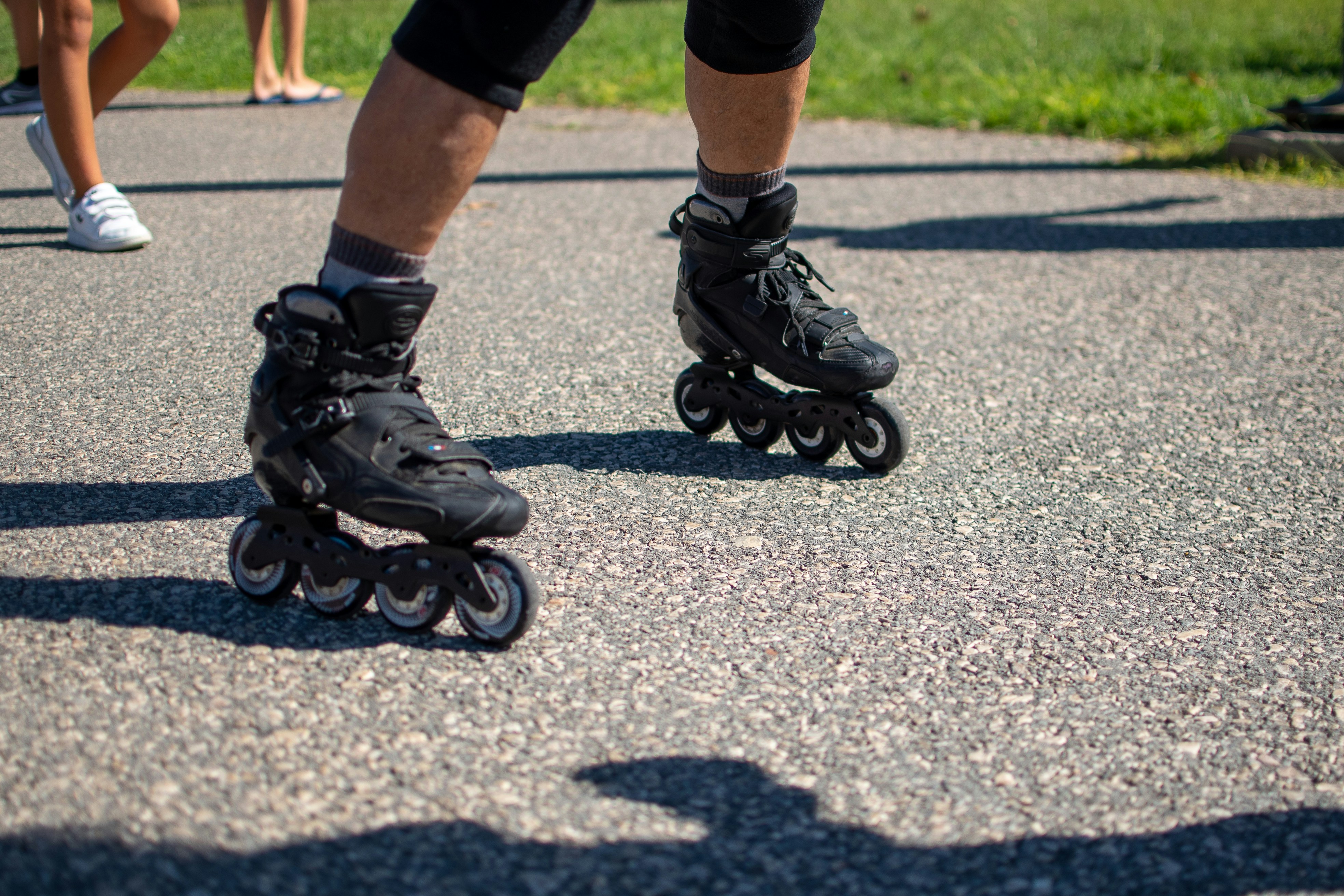 a group of people riding roller skates down a street