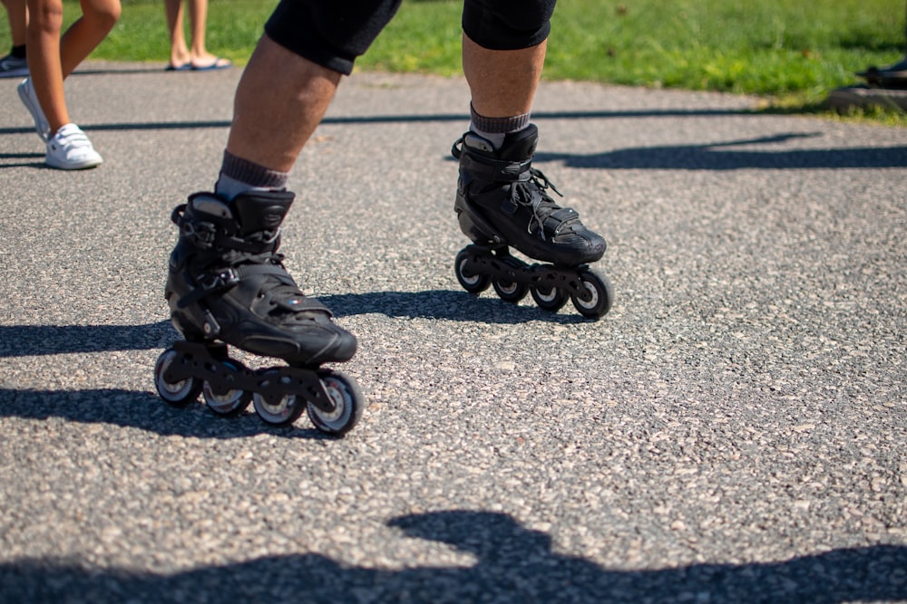 a group of people riding roller skates down a street