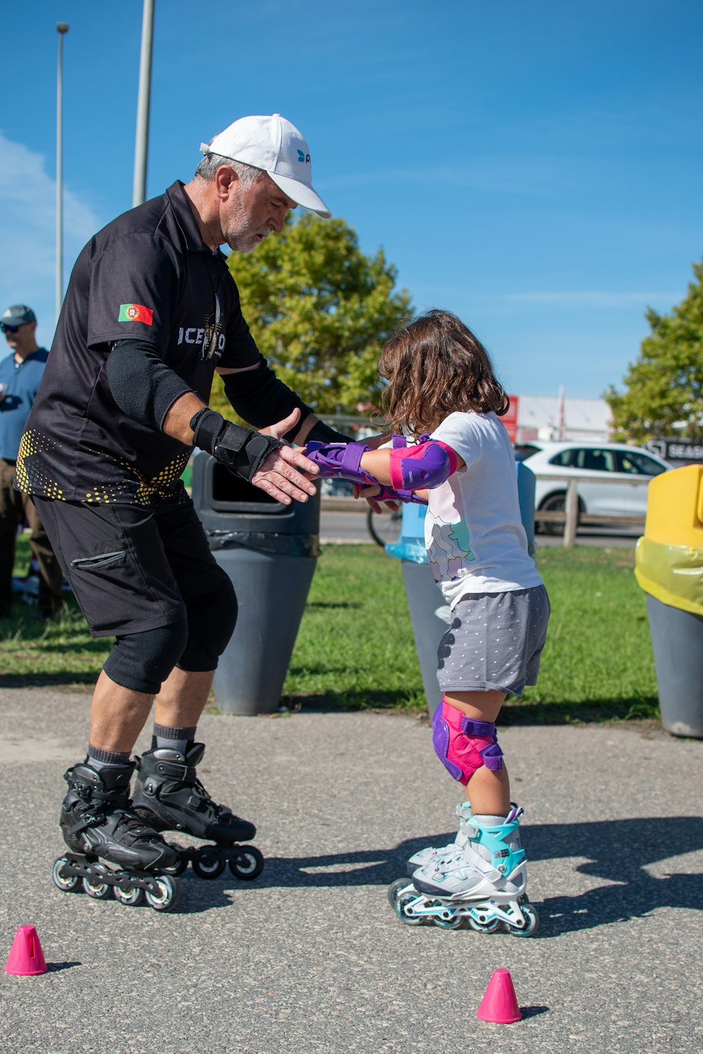a man teaching a little girl how to skate