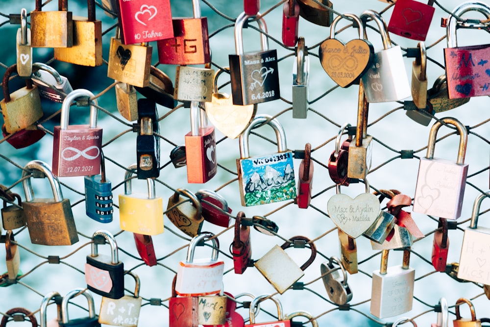 a bunch of padlocks are attached to a fence