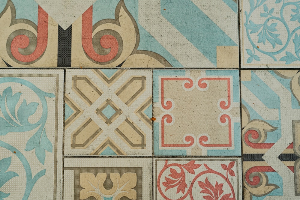 a close up of a tiled wall with different designs