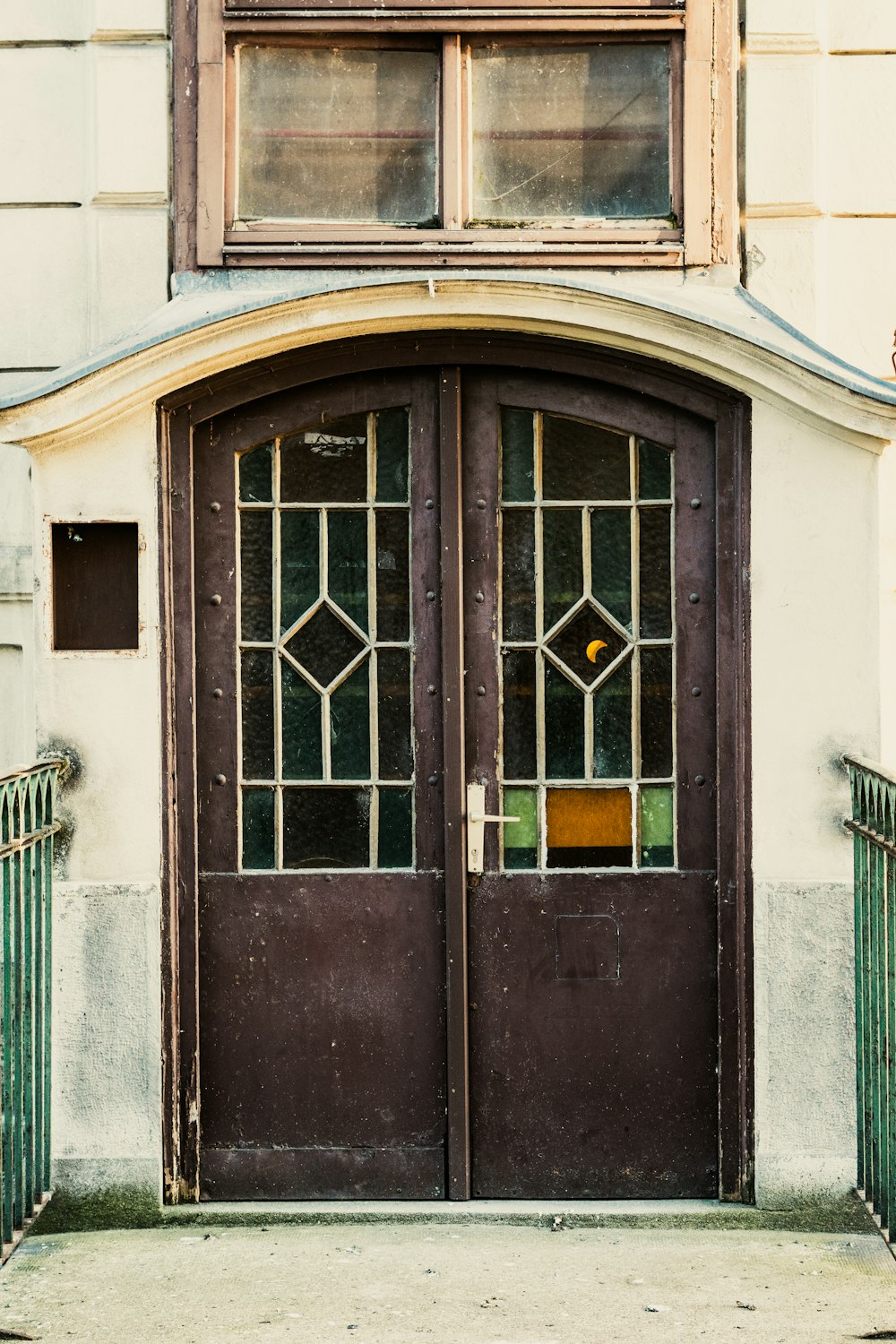 a couple of brown doors sitting inside of a building