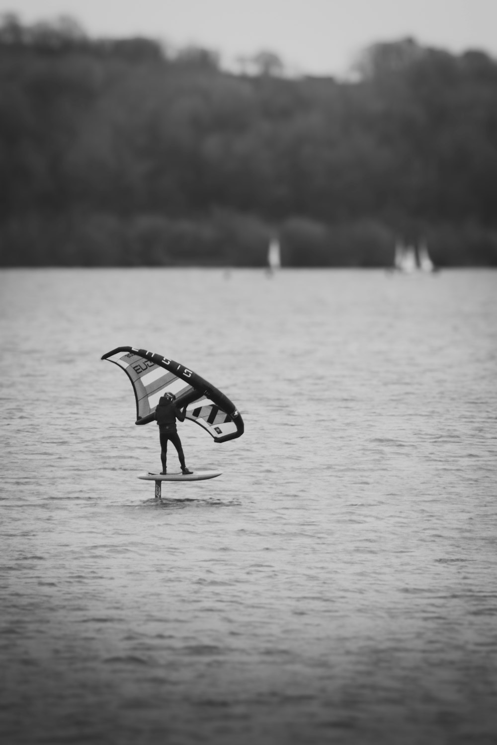 a person on a surfboard with a para sail