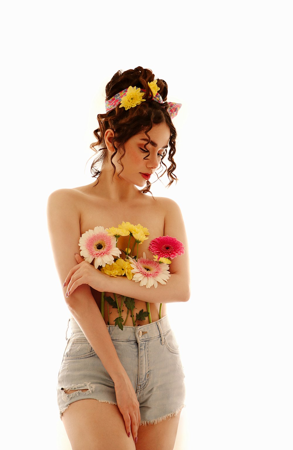 a woman with flowers in her hair holding a bouquet of flowers