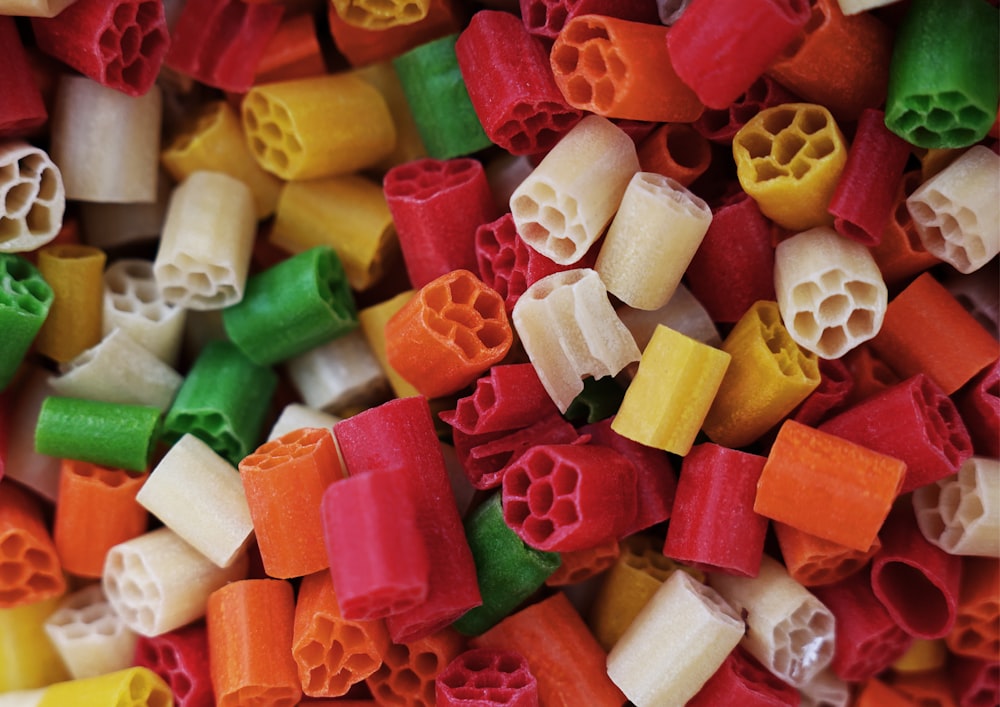 a close up of a pile of multicolored pasta noodles