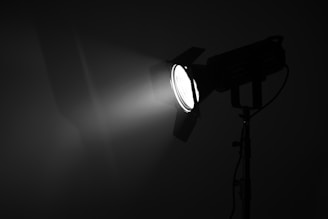 a black and white photo of a light in the dark