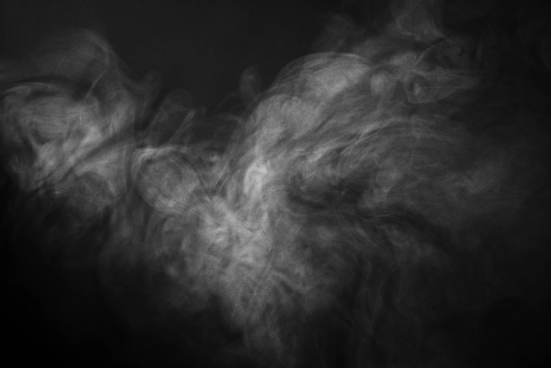 a black and white photo of smoke