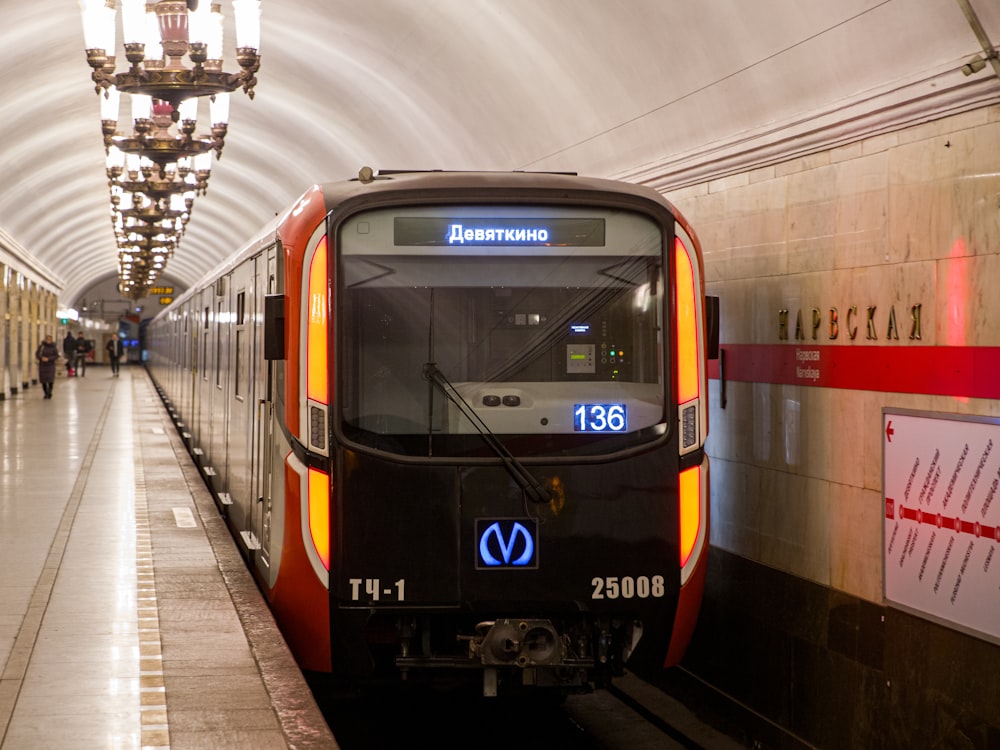 a train pulling into a train station next to a platform