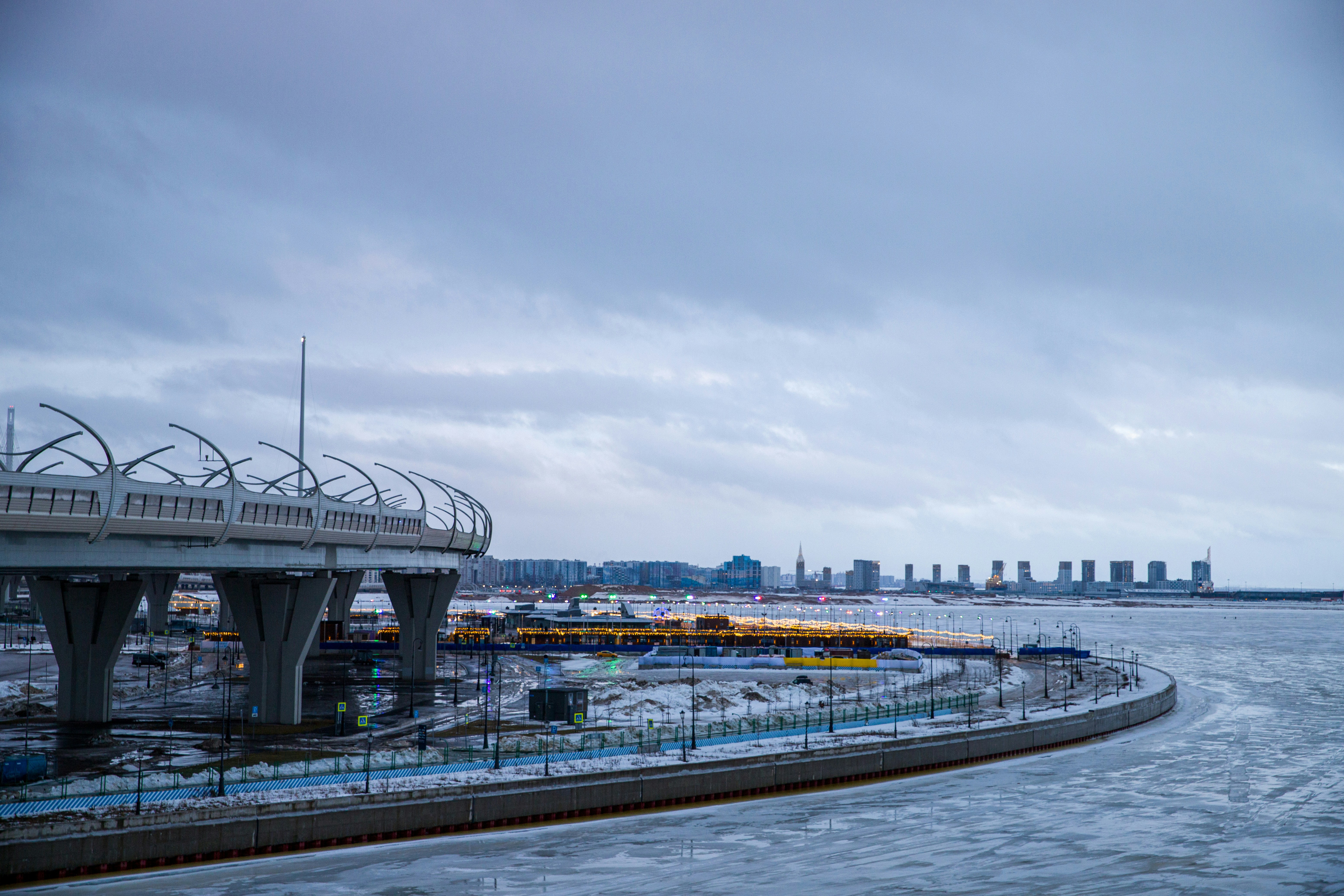 a bridge over a body of water with a city in the background