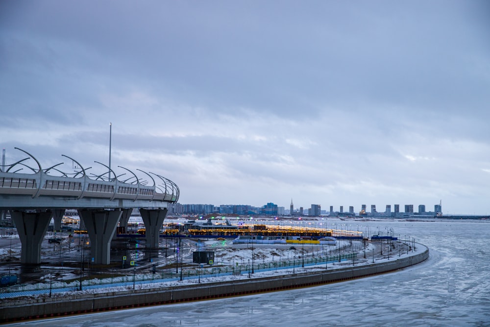 a bridge over a body of water with a city in the background