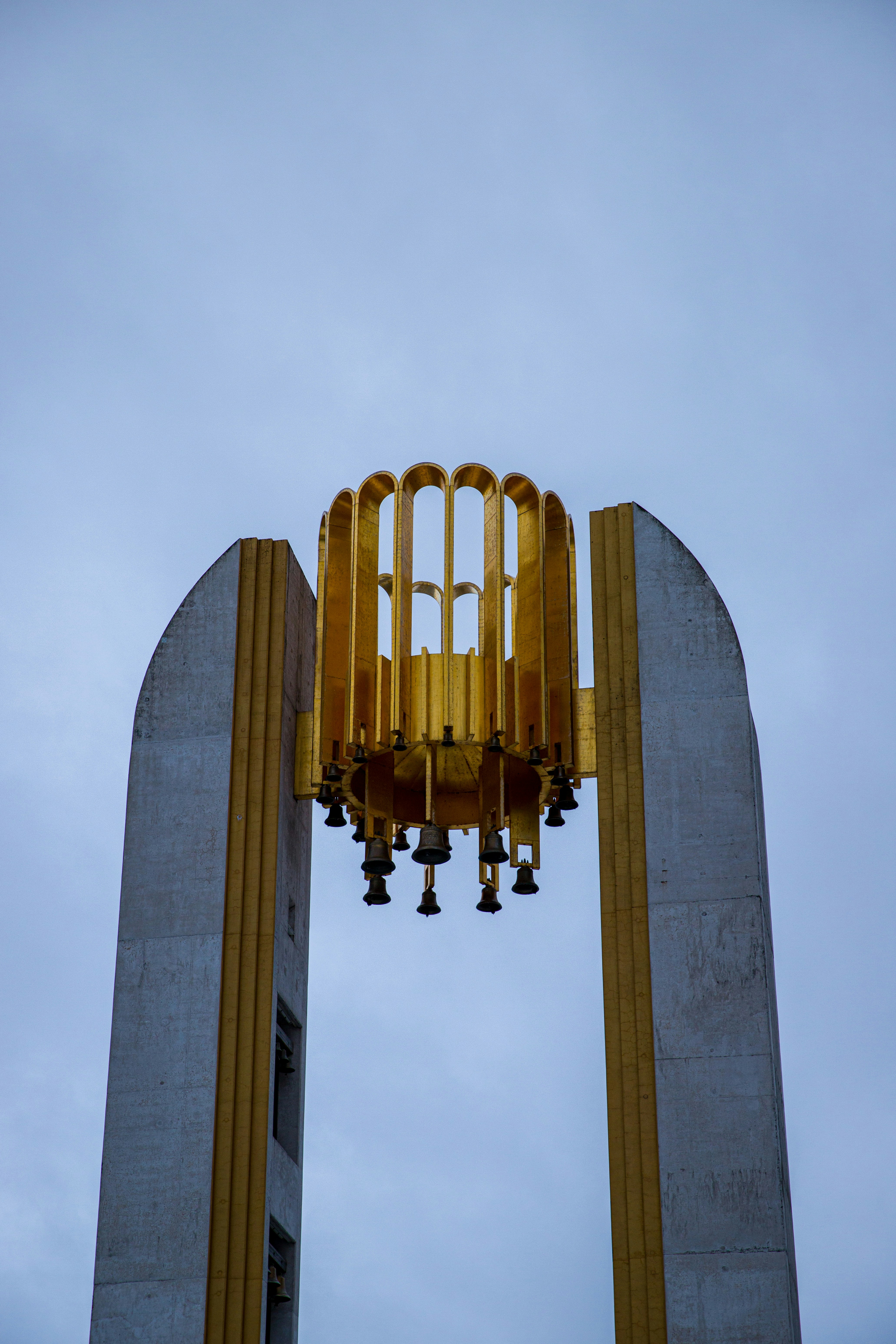 a large metal structure with a clock on top of it