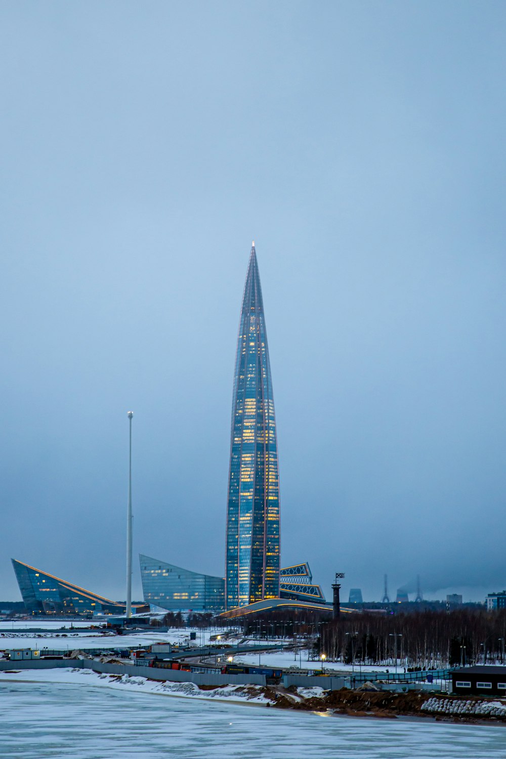 a very tall building sitting in the middle of a body of water