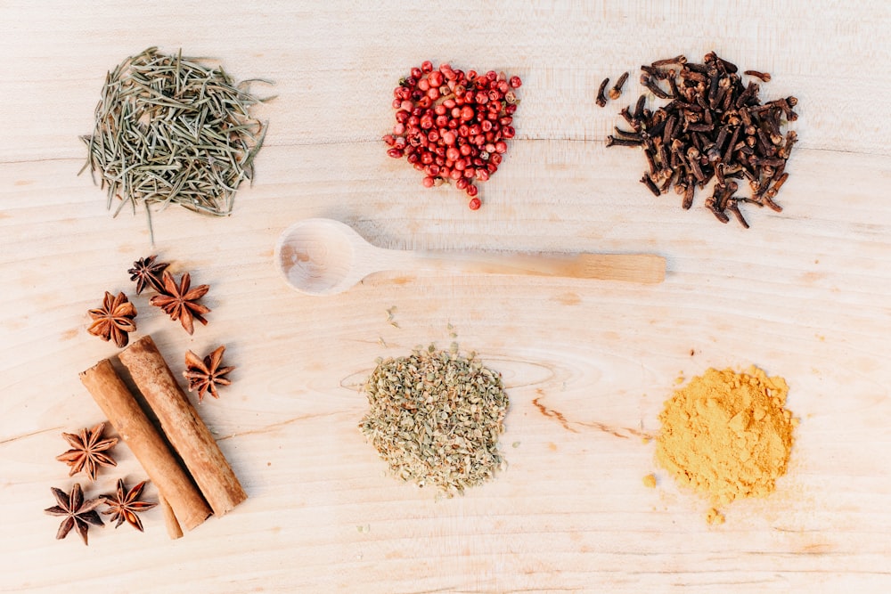 a wooden table topped with spices and herbs