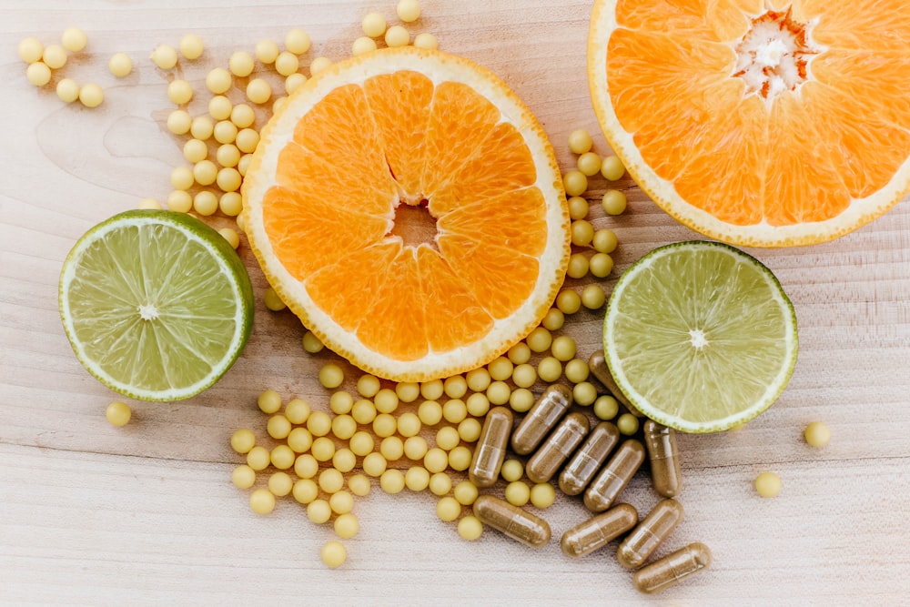 oranges, peas, and limes on a wooden table