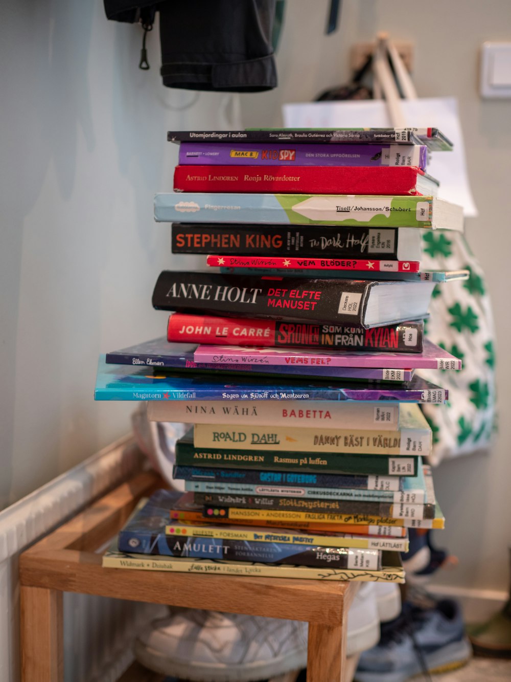 a stack of books sitting on top of a wooden table