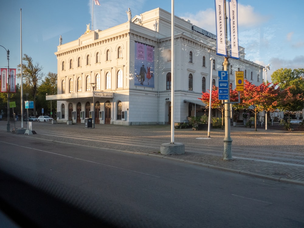 a large white building sitting on the side of a road