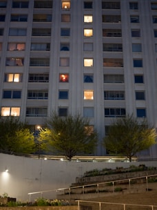 a tall building with a lot of windows at night