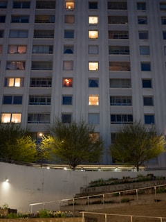 a tall building with a lot of windows at night