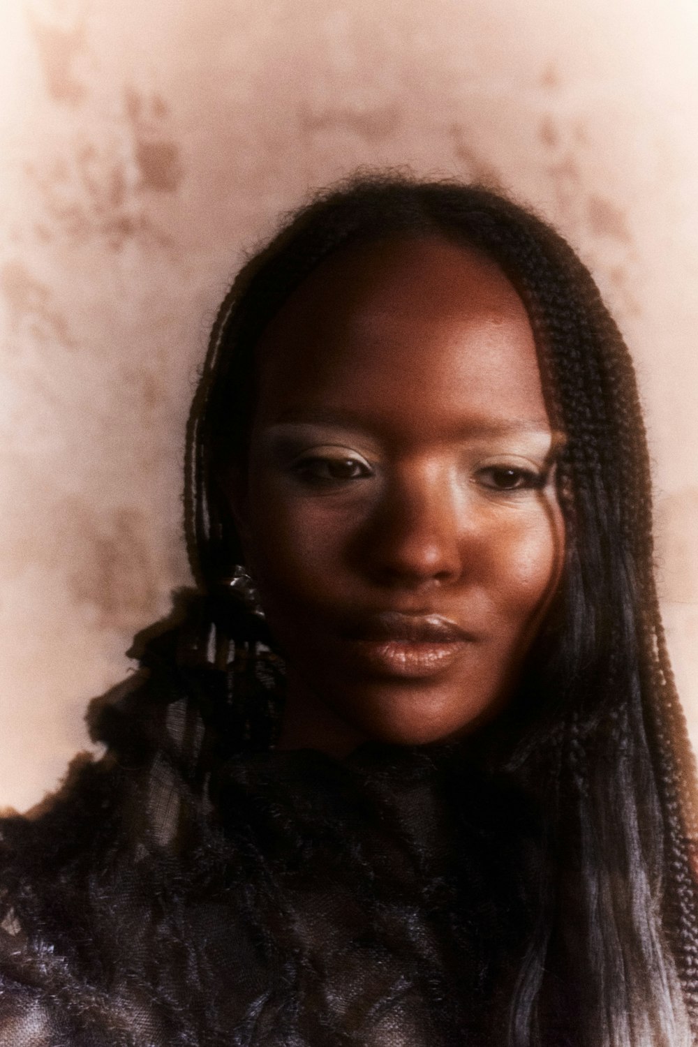 a woman with long braids is posing for a picture