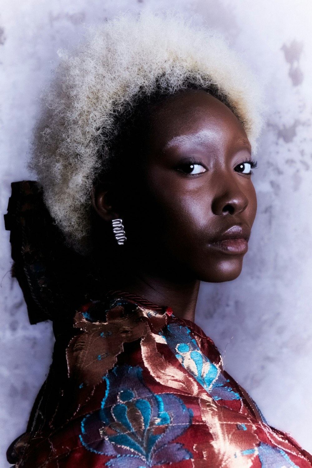 a woman with an afro is posing for a picture