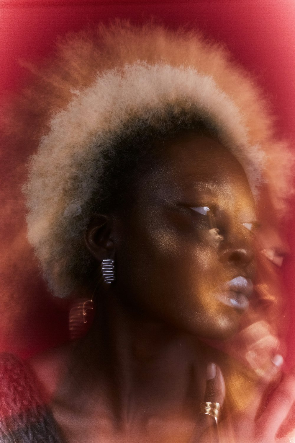 a woman with an afro is smoking a cigarette