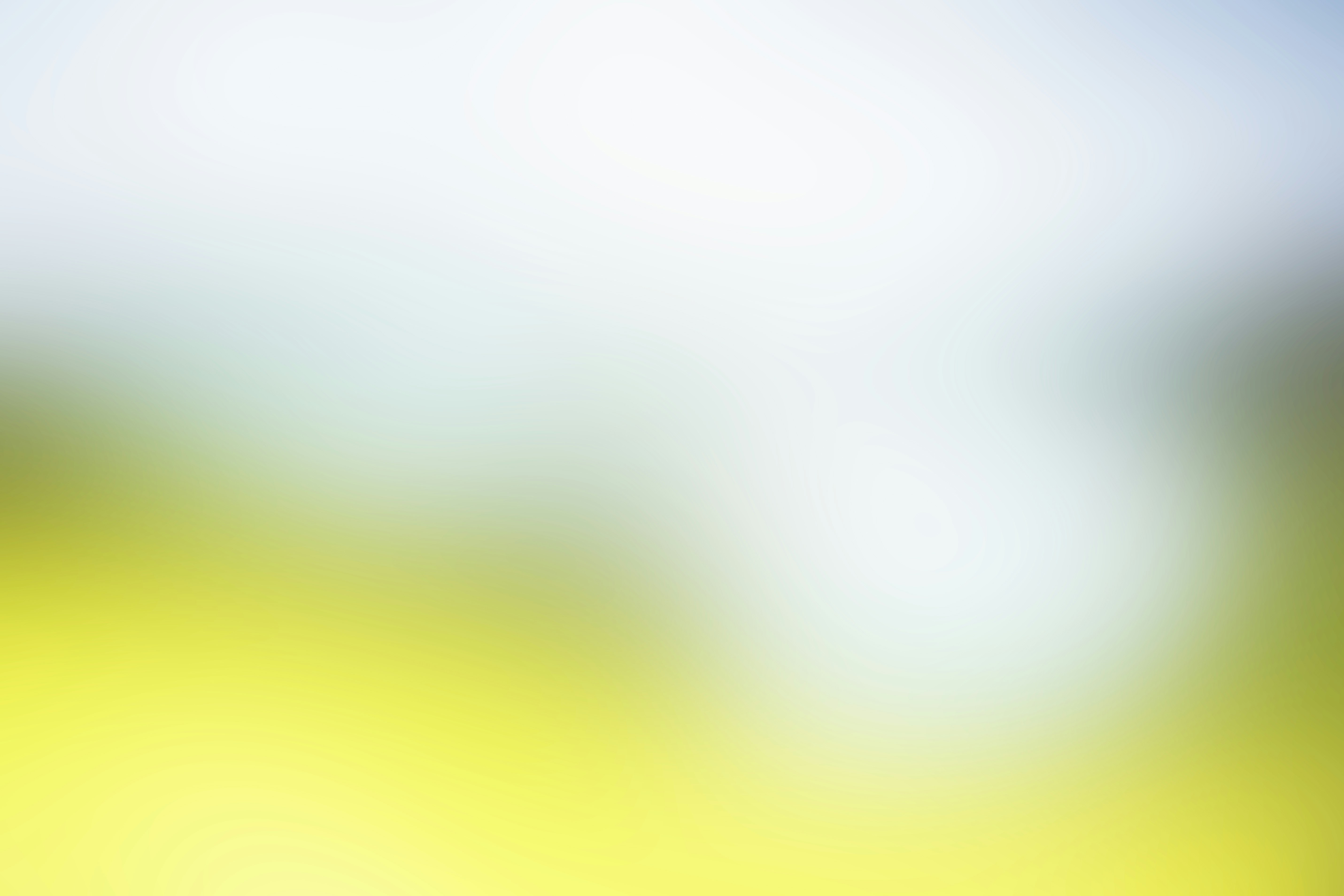 a blurry image of a yellow and blue sky