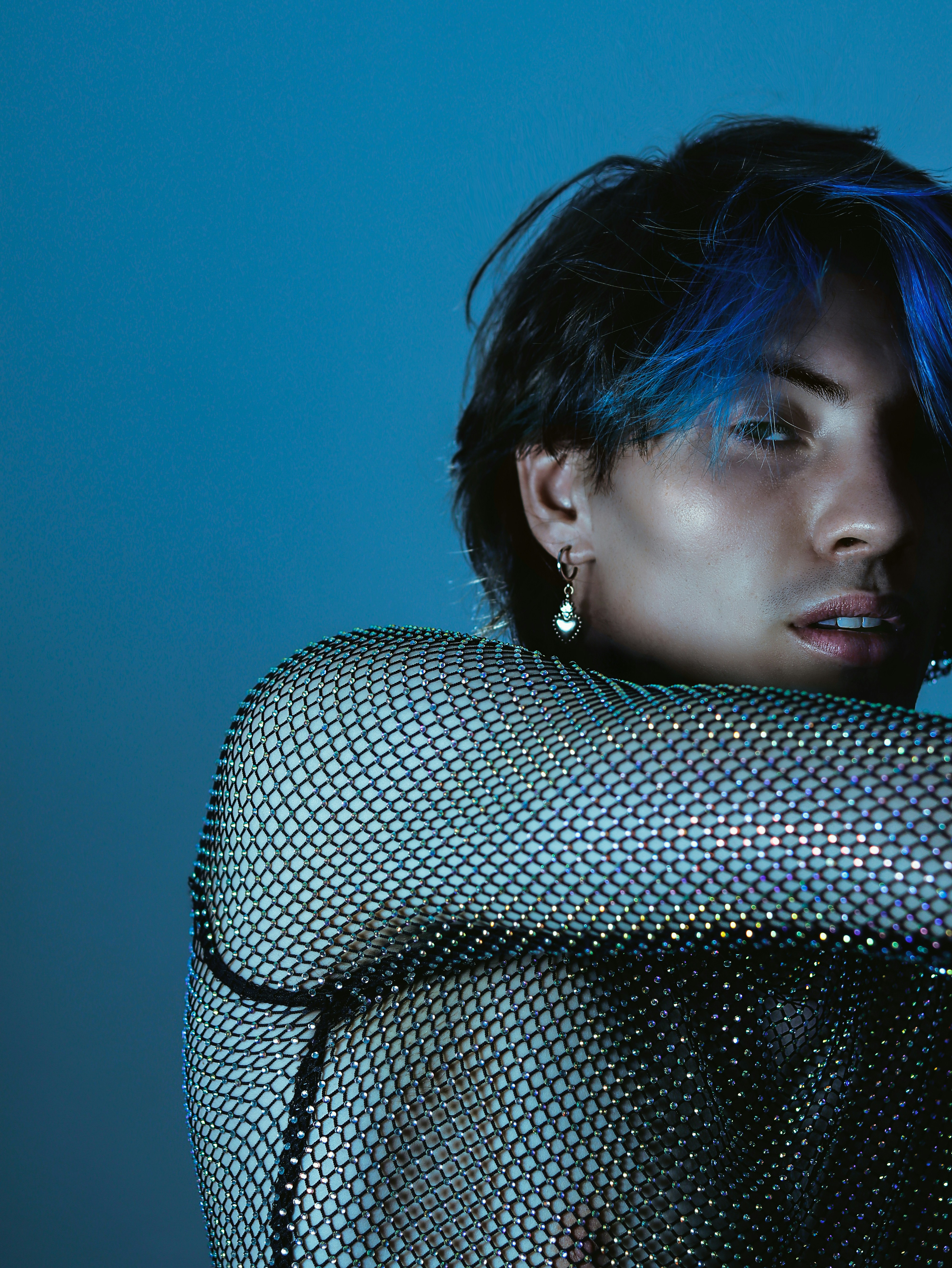 a woman with blue hair posing for a picture