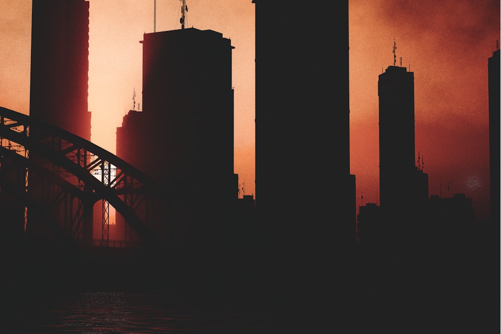 a picture of a city skyline with a bridge in the foreground