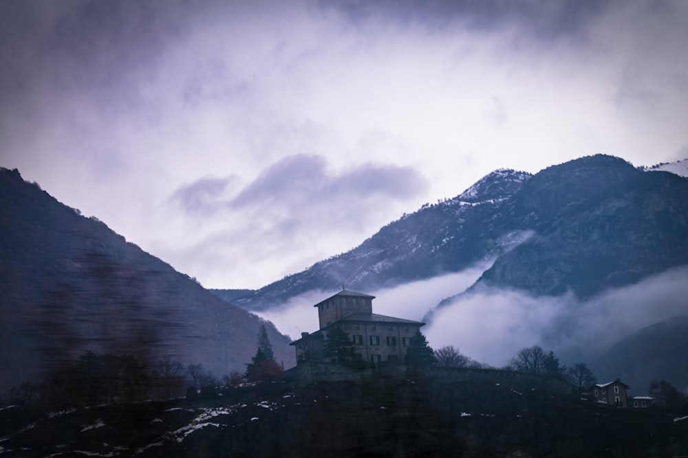 a house on a hill with a mountain in the background