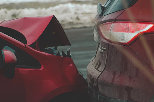 a red car parked next to another red car