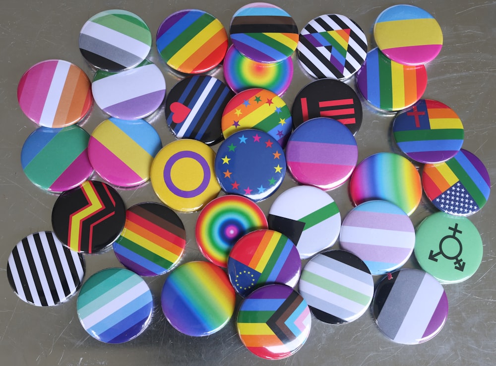 a pile of colorful buttons sitting on top of a table