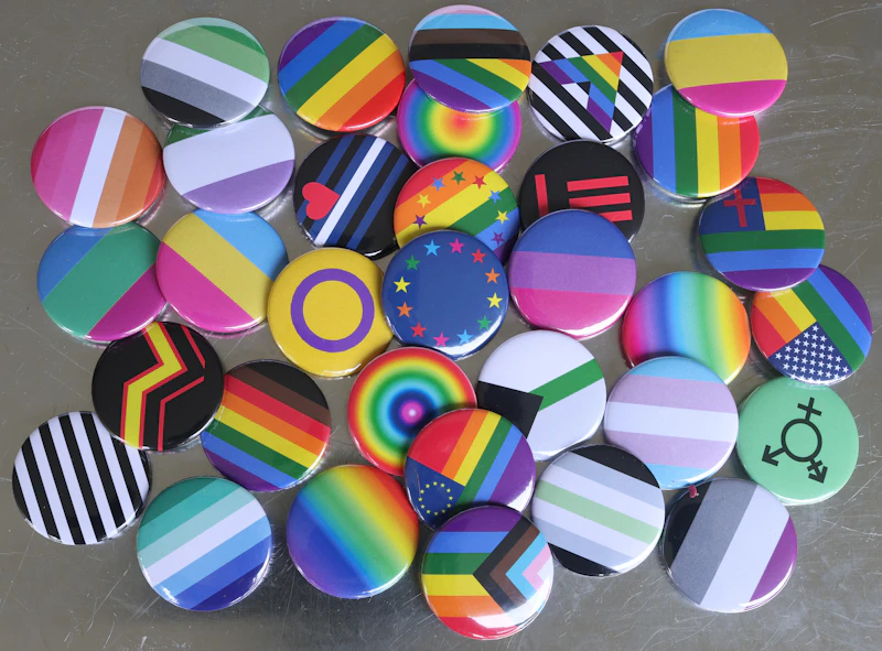 Pile of colorful Femboy chat community buttons