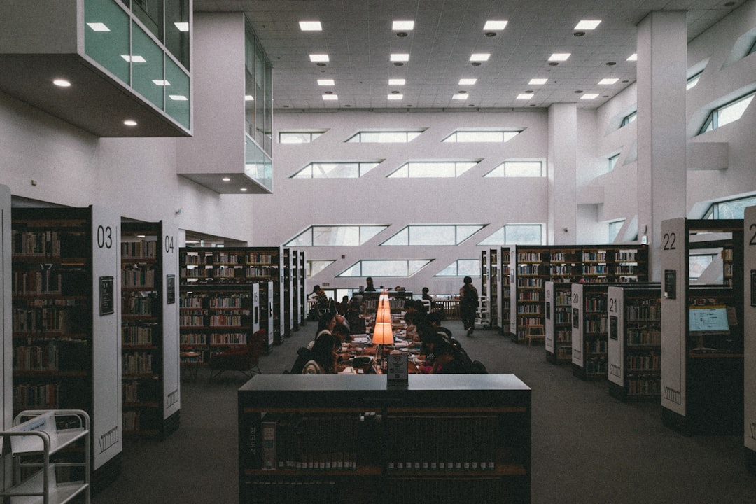 a library filled with lots of books and people,