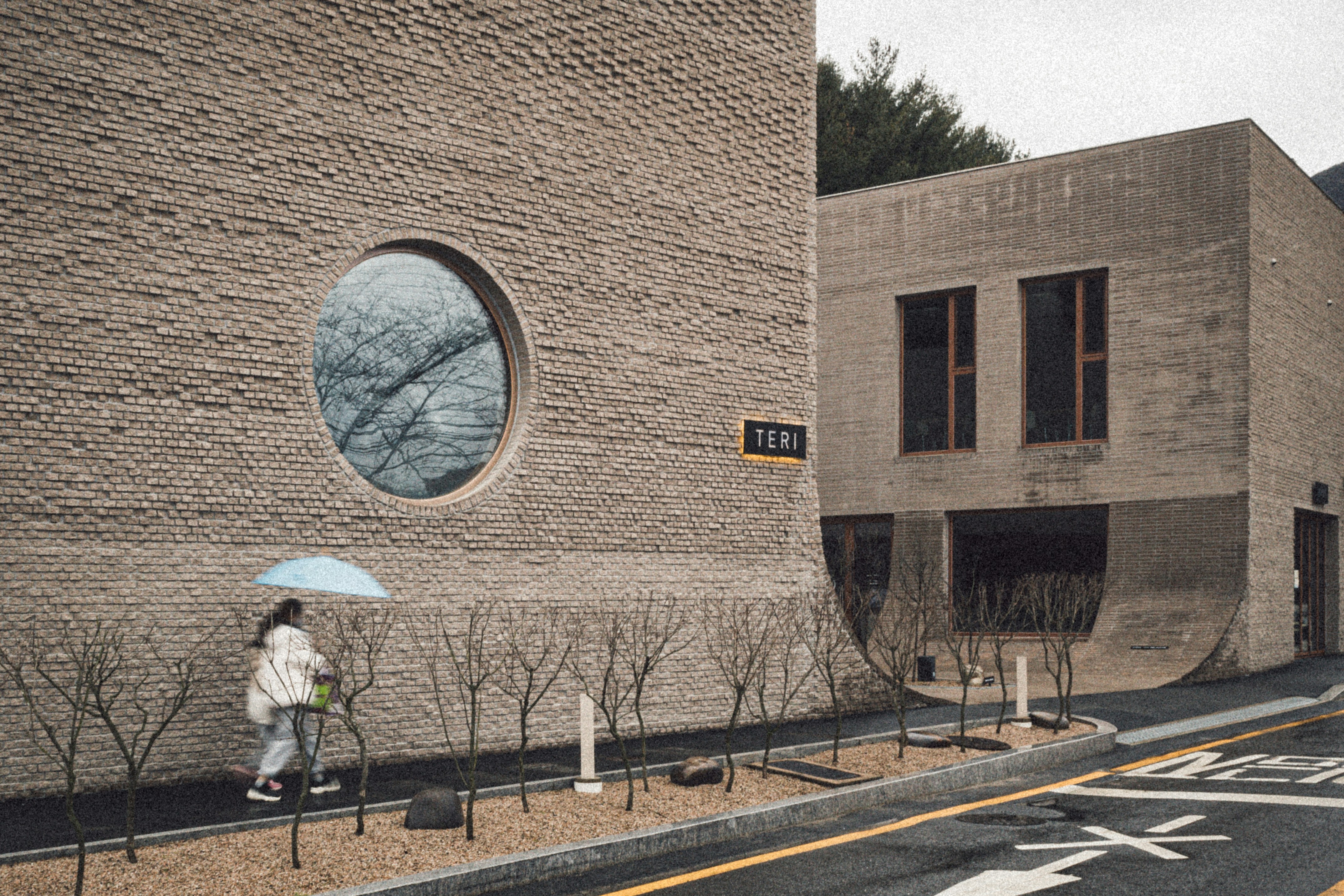a person walking down a street with an umbrella
