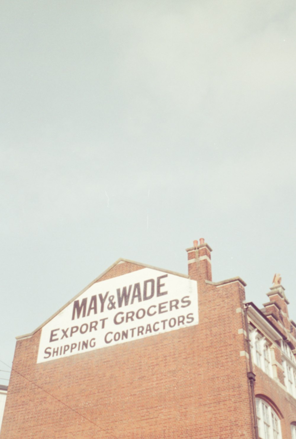 a brick building with a sign that says may and wade