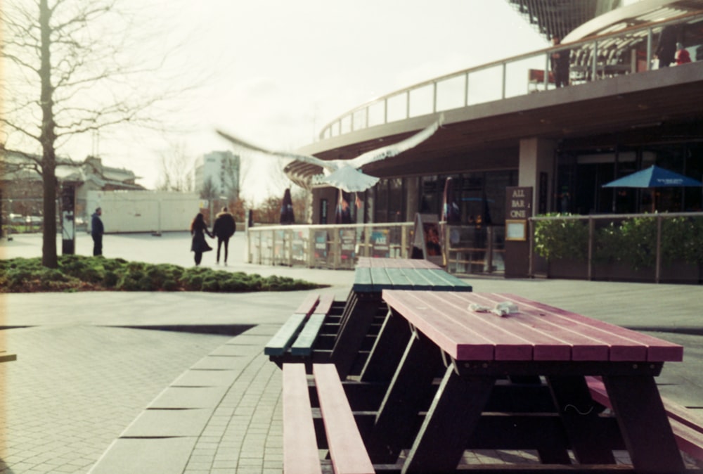 a couple of benches sitting on top of a sidewalk