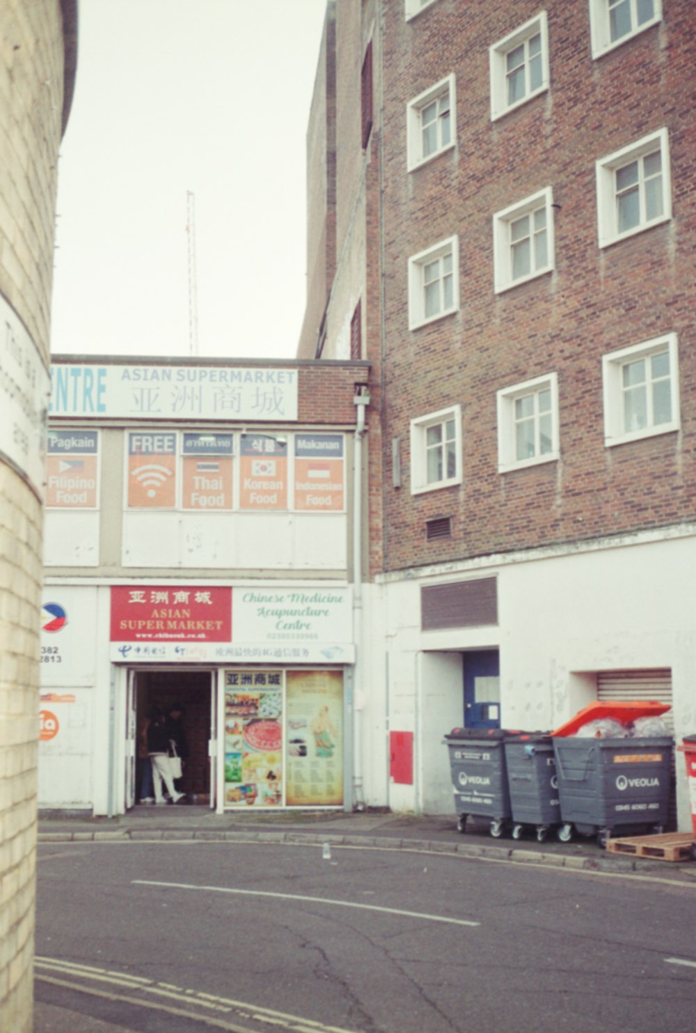 a street corner with a brick building in the background