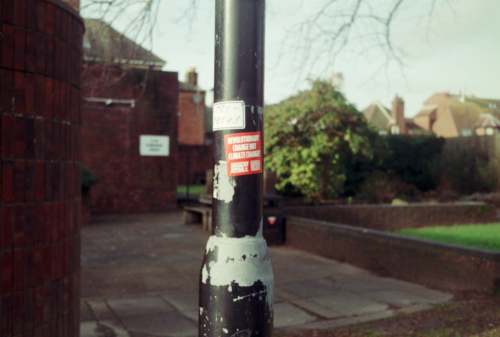 a black pole with a red and white sticker on it