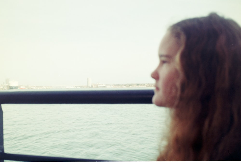 a woman looking out over a body of water