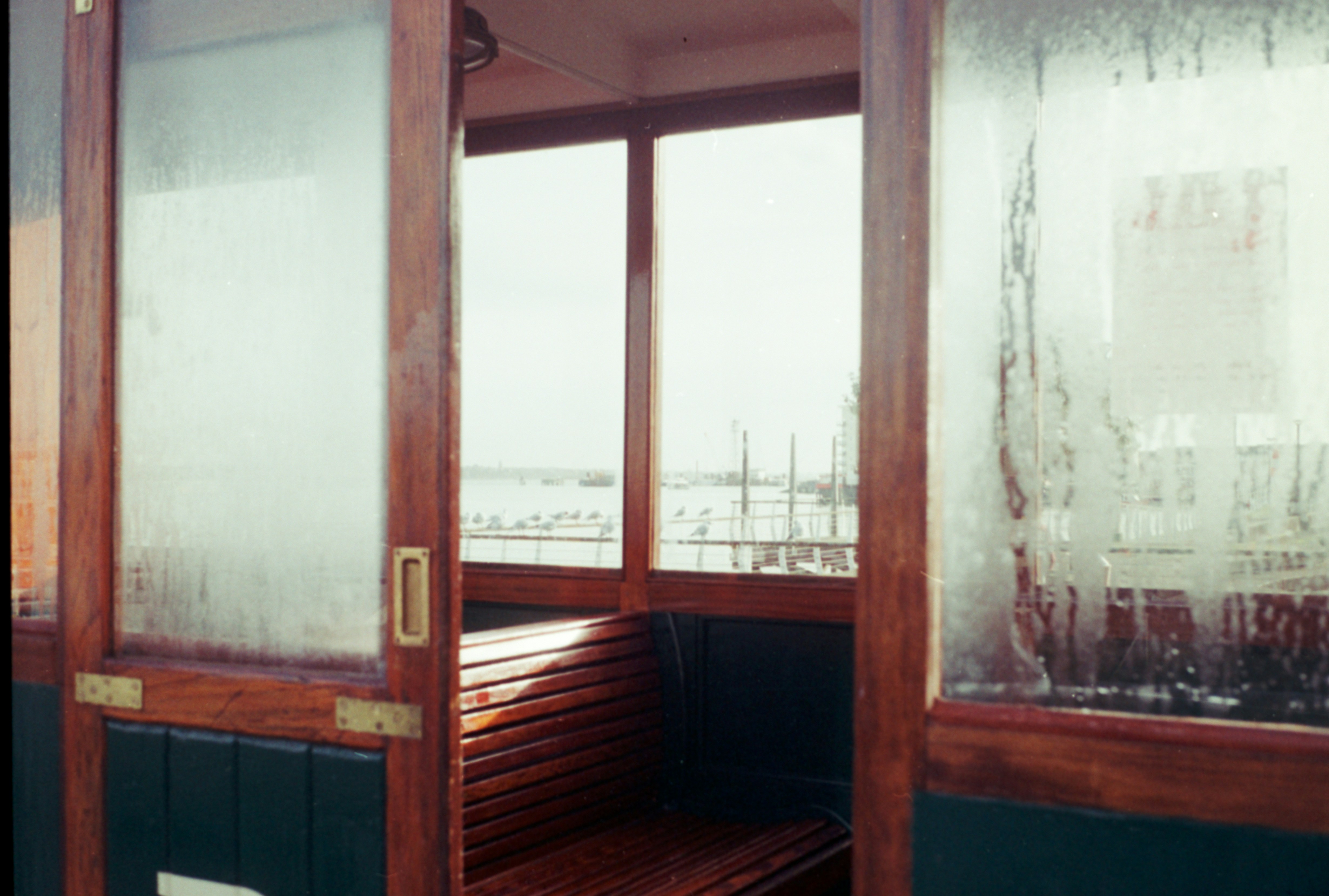 A wooden bench sitting in front of a window photo – Free Film ...