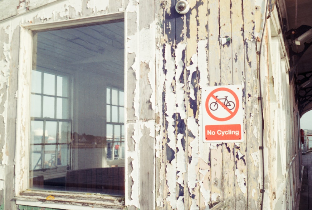 a no cycling sign on the side of a building