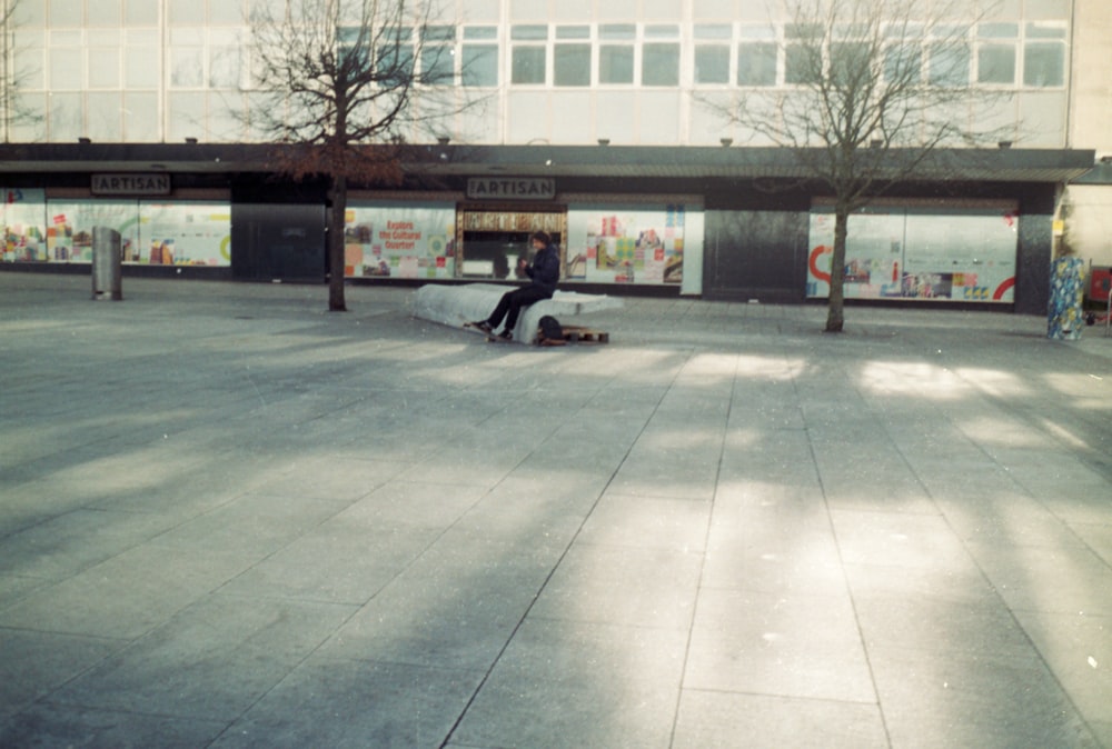 a man riding a skateboard on top of a sidewalk